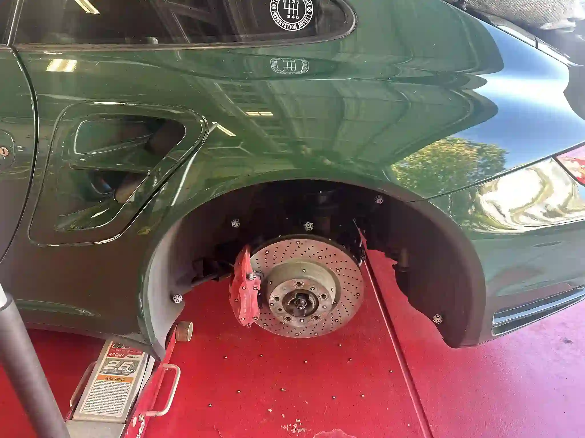 The wheel well of a Porsche 997, with the wheel removed to show the disc brake